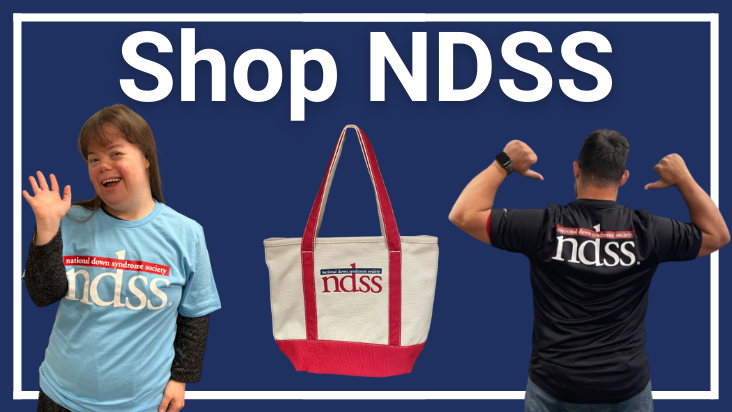 Shop NDSS. Charlotte, a woman with Down syndrome, wears a blue NDSS shirt. NDSS Lands End tote bag. A Man with Down syndrome shows that the back of his black NDSS shirt