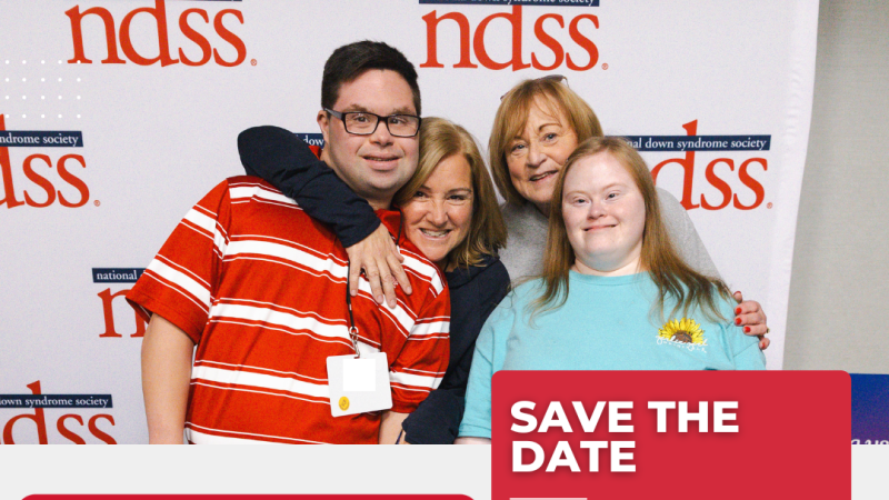 two adults with down syndrome pose and smile with their caregivers