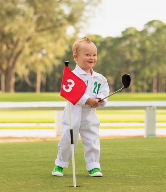 Boy with down syndrome golfing
