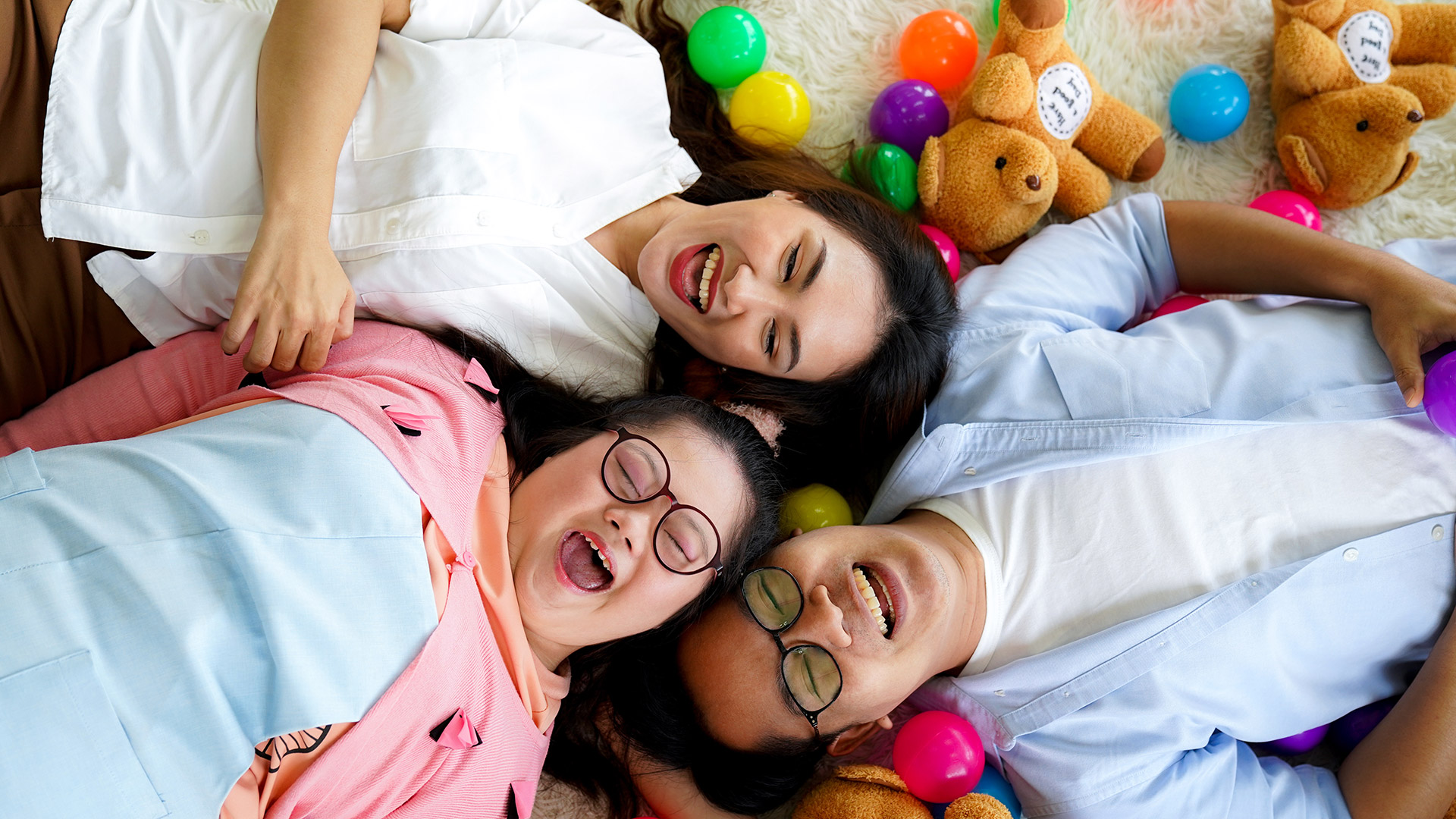 Family playfully lying on the floor