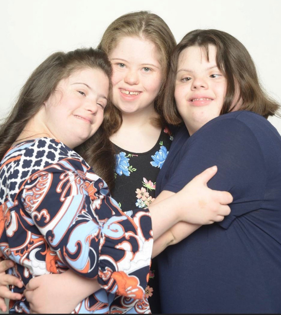 Three girls hugging