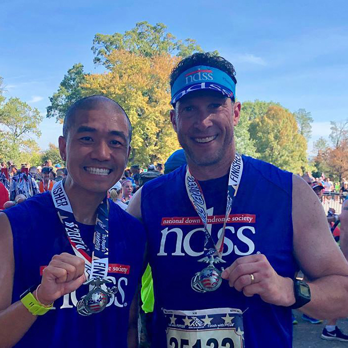 Two men in NDSS-branded running gear