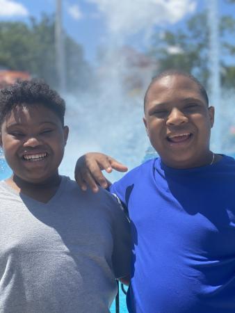 two young boys with Down syndrome smiling
