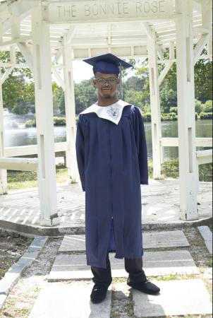 man with down syndrome and his graduation gown