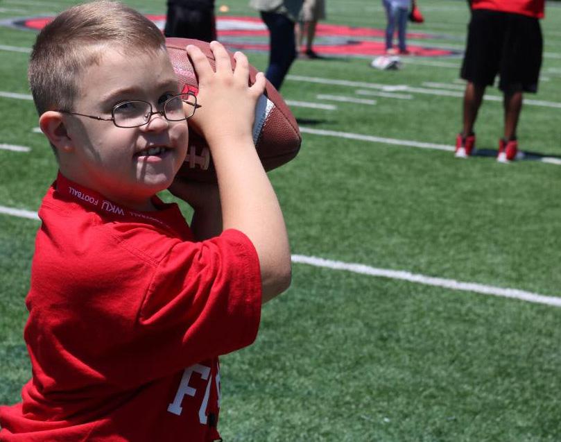 Child holds football