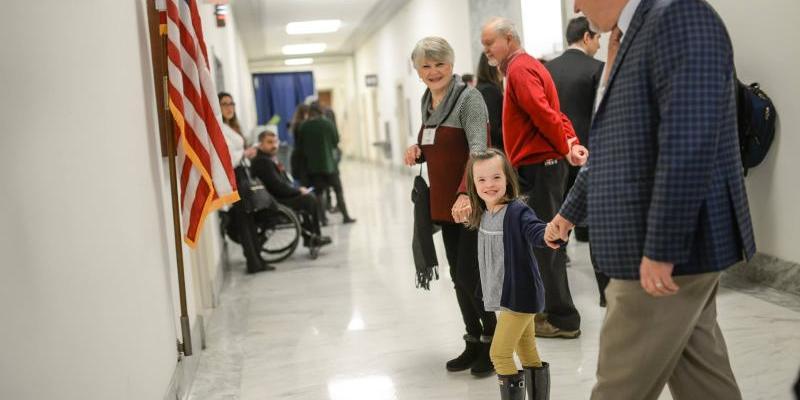 Young girl walks with older couple